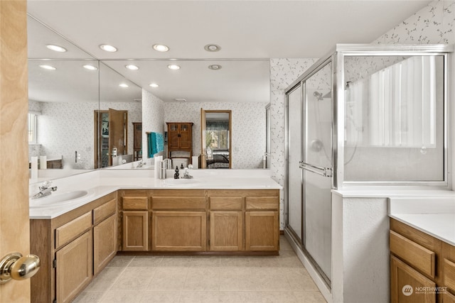 bathroom featuring a wealth of natural light, vanity, and an enclosed shower