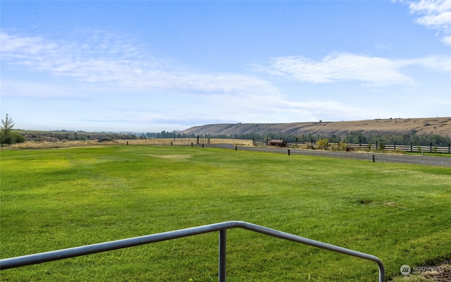 view of yard with a mountain view and a rural view