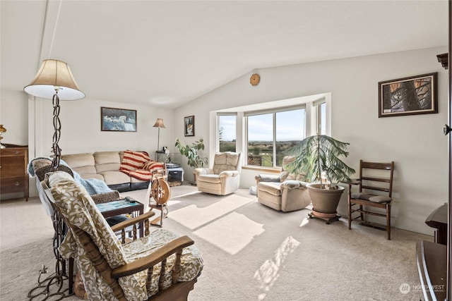 carpeted living area with vaulted ceiling