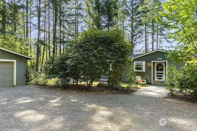 view of front of home with entry steps, driveway, and a garage