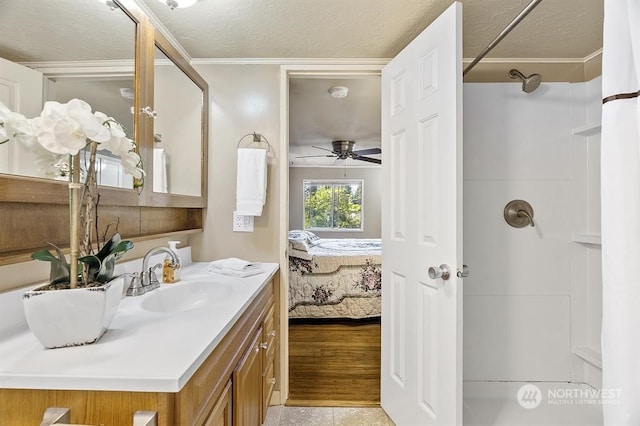 full bathroom featuring a shower, connected bathroom, vanity, and a textured ceiling