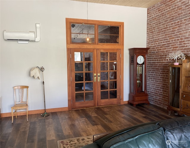 unfurnished living room featuring dark wood-type flooring, a wall mounted AC, and brick wall