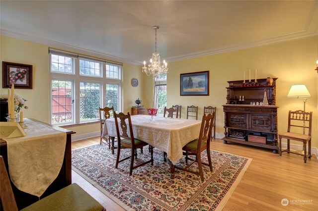 dining room featuring hardwood / wood-style flooring, a chandelier, and crown molding