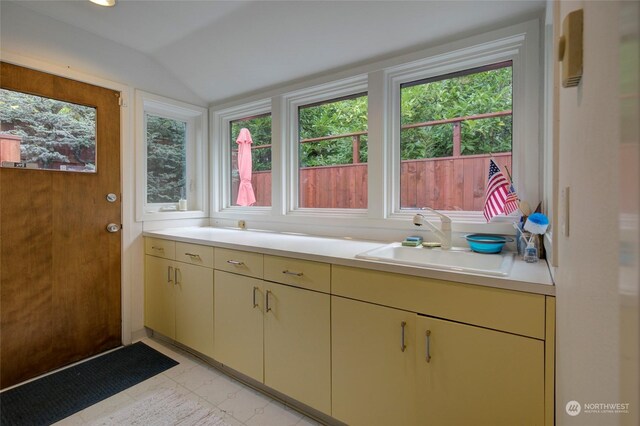 bathroom with lofted ceiling and vanity