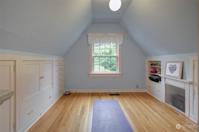 bonus room featuring light wood-type flooring and lofted ceiling