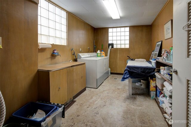 washroom with wooden walls and washer and dryer