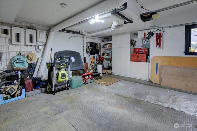 garage with electric panel and a garage door opener