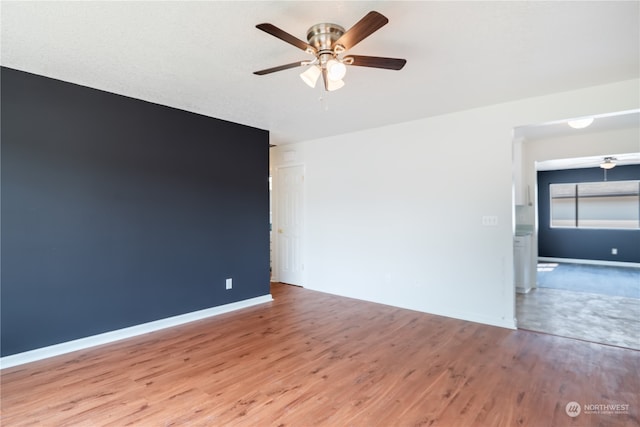 empty room with ceiling fan and hardwood / wood-style floors