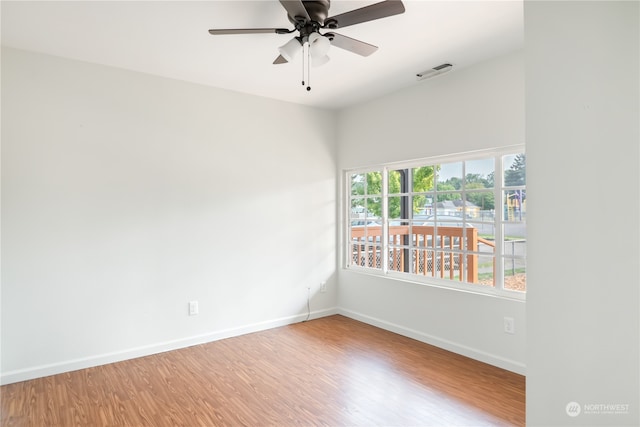 empty room with ceiling fan and wood-type flooring