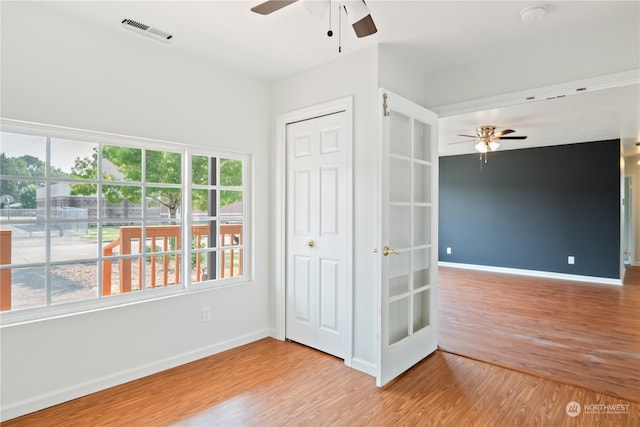 empty room with light wood-type flooring and ceiling fan