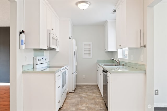 kitchen with sink, white appliances, and white cabinets