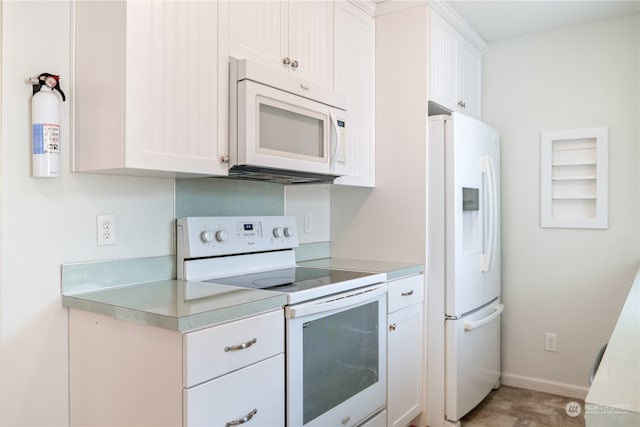 kitchen featuring white appliances and white cabinets