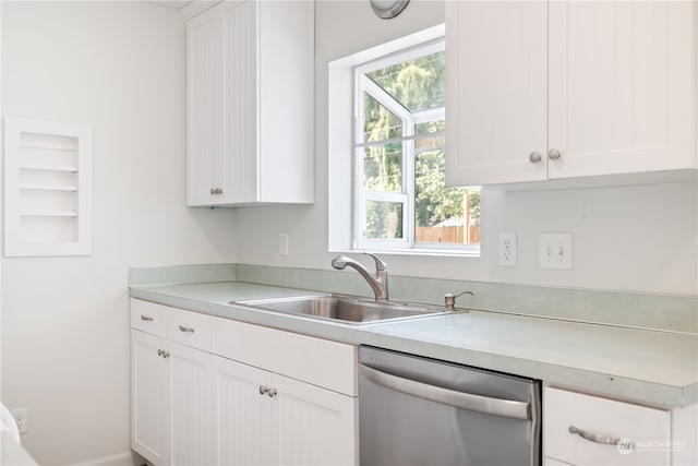 kitchen with dishwasher, white cabinetry, and sink