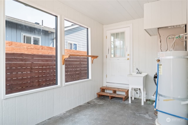 washroom with strapped water heater and wood walls