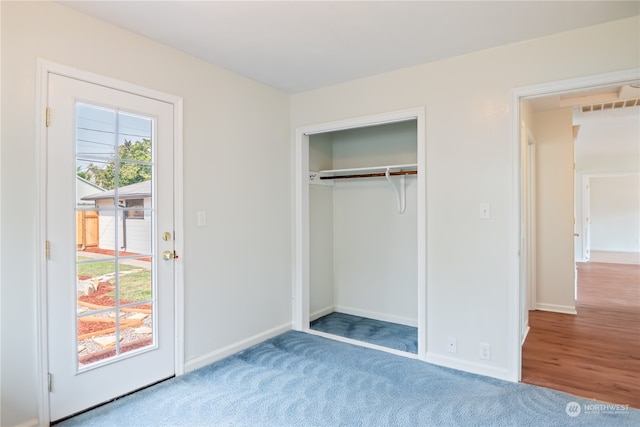 unfurnished bedroom with a closet and hardwood / wood-style flooring