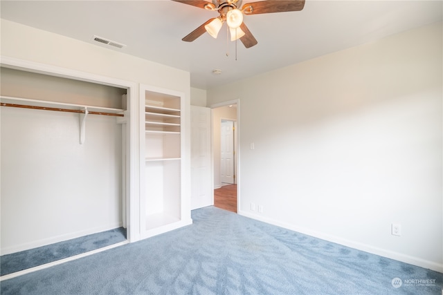 unfurnished bedroom with carpet, ceiling fan, and a closet