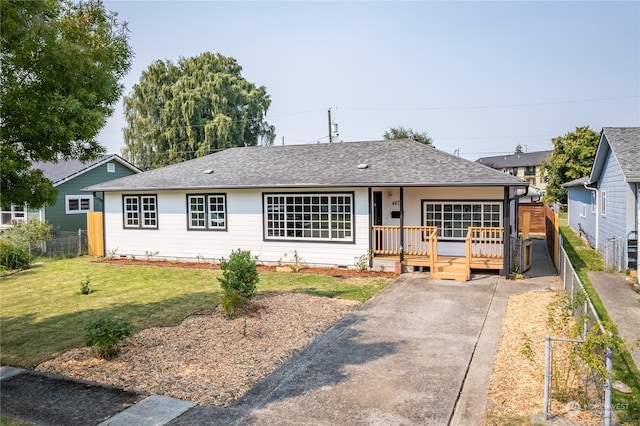 ranch-style house with a front lawn and a deck