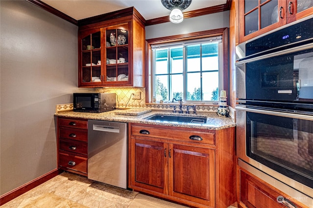 kitchen featuring crown molding, appliances with stainless steel finishes, light stone countertops, sink, and decorative backsplash