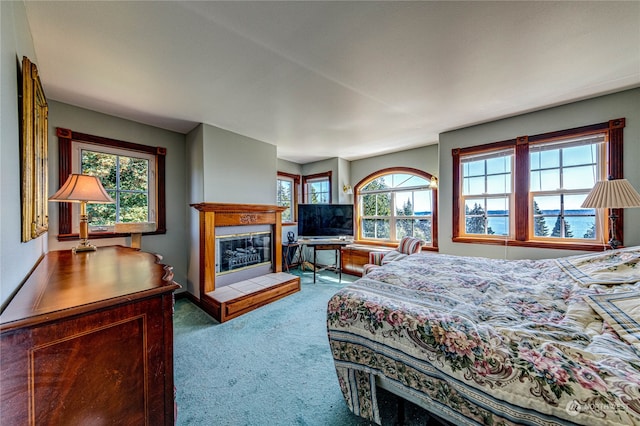 carpeted bedroom with a fireplace