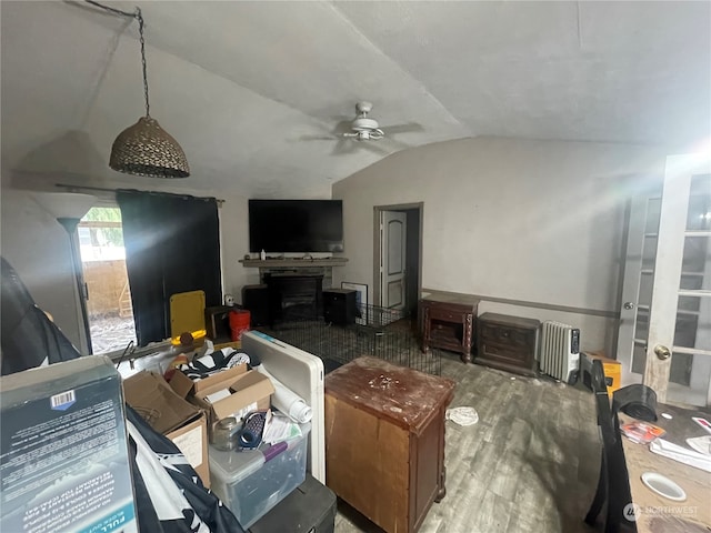 living room with ceiling fan, lofted ceiling, and hardwood / wood-style floors