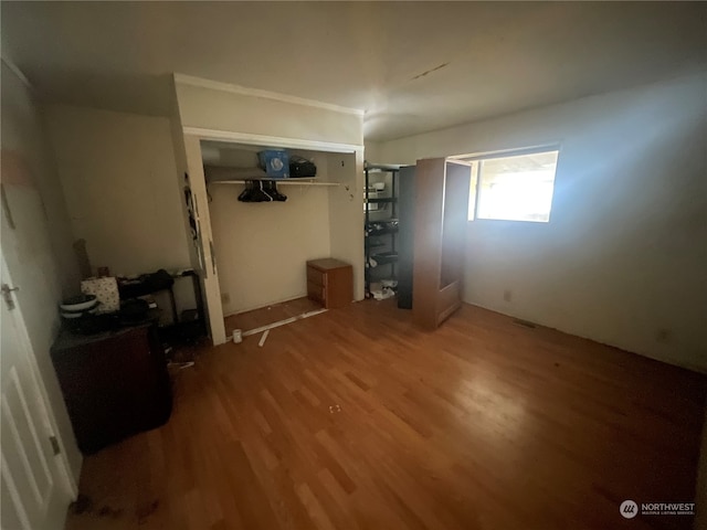 unfurnished bedroom featuring a closet and hardwood / wood-style floors