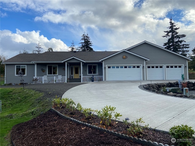 ranch-style home featuring a garage and covered porch