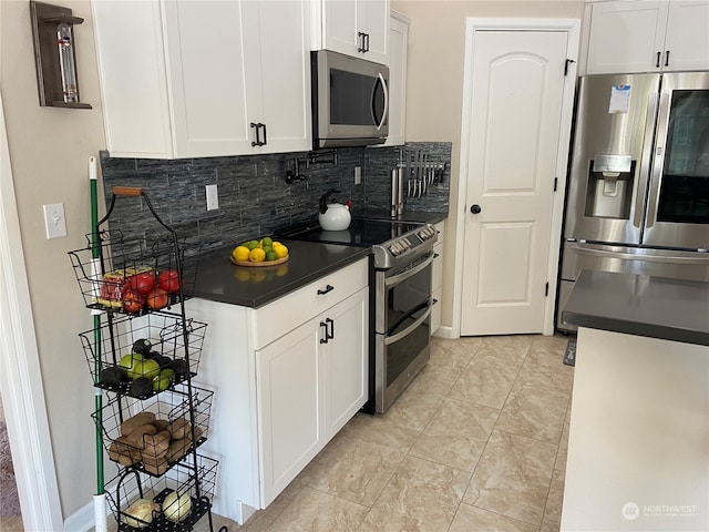 kitchen with stainless steel appliances, white cabinetry, and tasteful backsplash