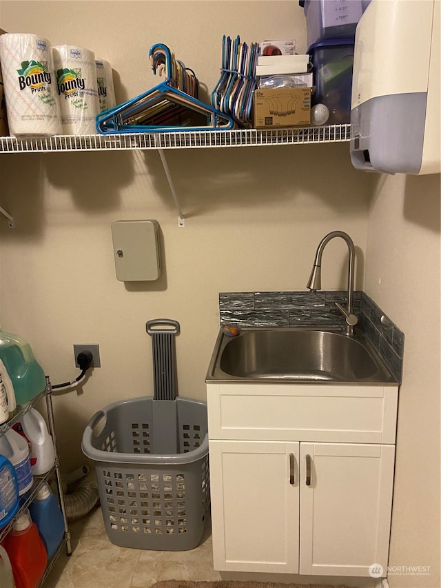 interior space featuring electric dryer hookup, cabinets, and sink