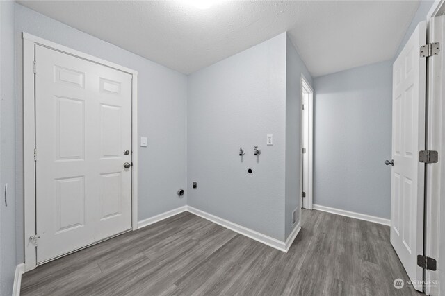 laundry area with hookup for a washing machine, hardwood / wood-style flooring, electric dryer hookup, and a textured ceiling