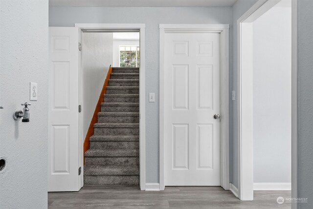 stairs featuring hardwood / wood-style floors