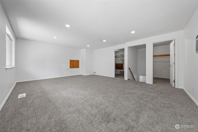 unfurnished bedroom with carpet flooring and a textured ceiling