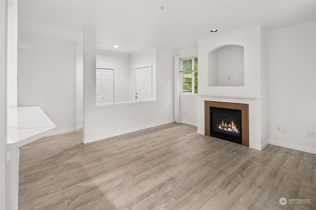 unfurnished living room featuring light hardwood / wood-style floors