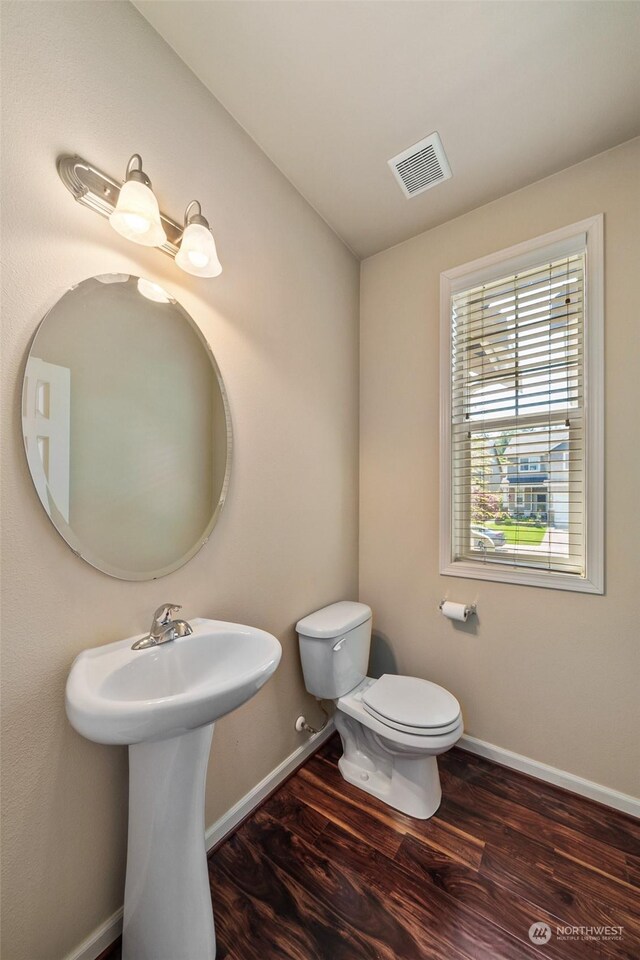 bathroom featuring toilet and hardwood / wood-style flooring