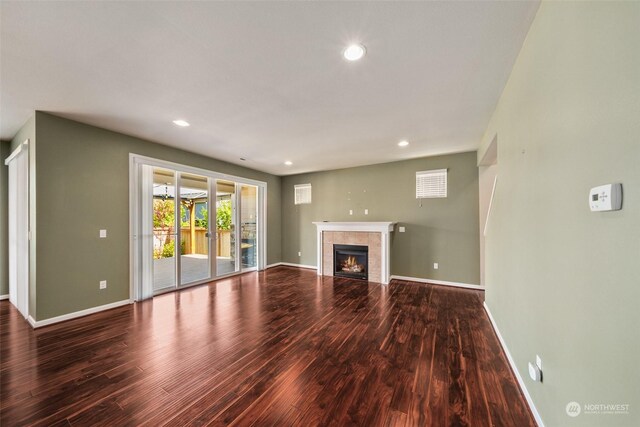 unfurnished living room featuring hardwood / wood-style floors and a fireplace