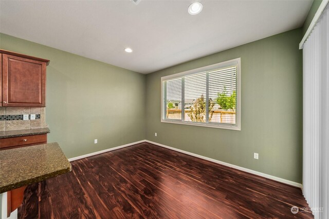 unfurnished dining area with dark hardwood / wood-style flooring