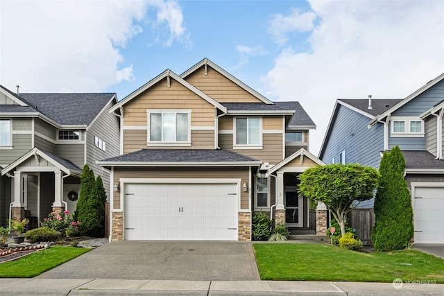 craftsman-style home with a garage and a front lawn