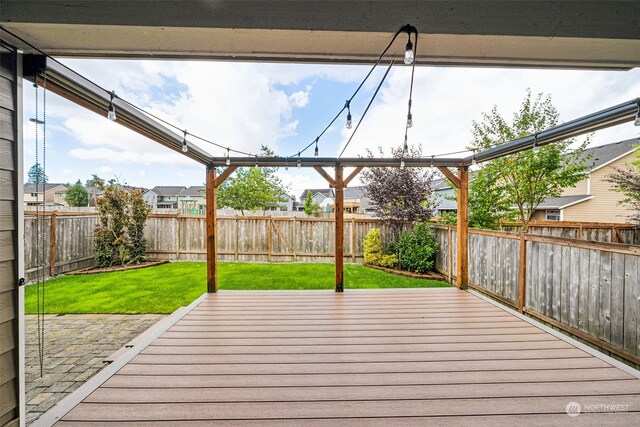 wooden deck with a lawn