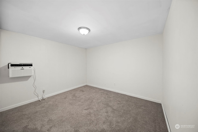 empty room featuring carpet floors and an AC wall unit