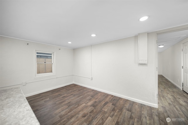 empty room with dark hardwood / wood-style flooring