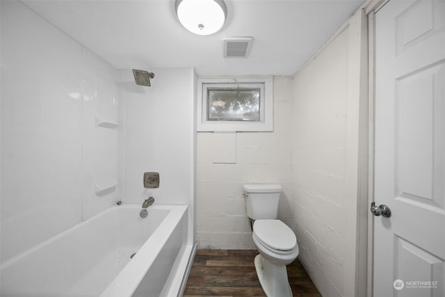 bathroom with hardwood / wood-style floors,  shower combination, and toilet