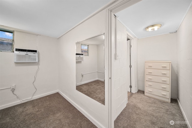 hallway with a wall mounted AC and carpet floors