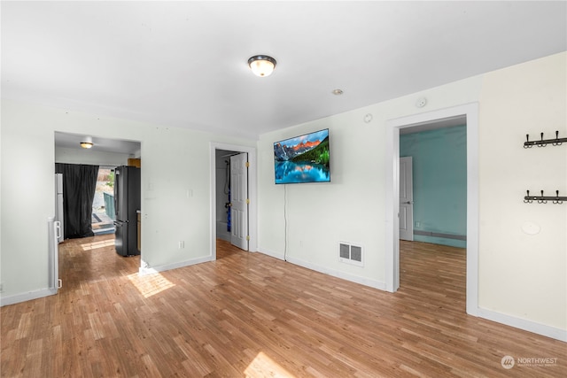 unfurnished room with light hardwood / wood-style floors