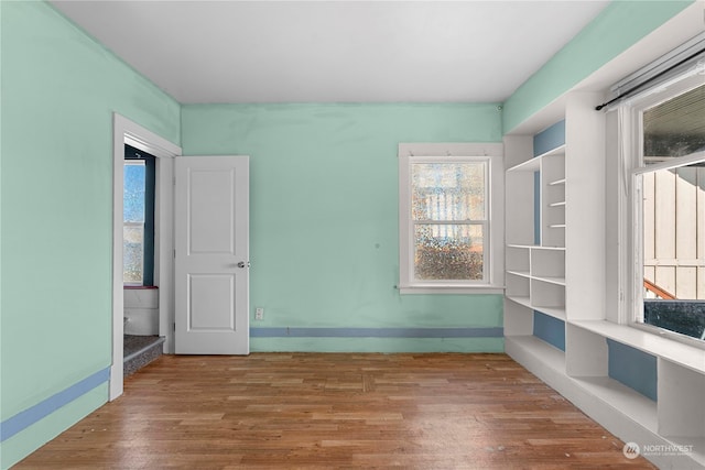 unfurnished room featuring hardwood / wood-style floors