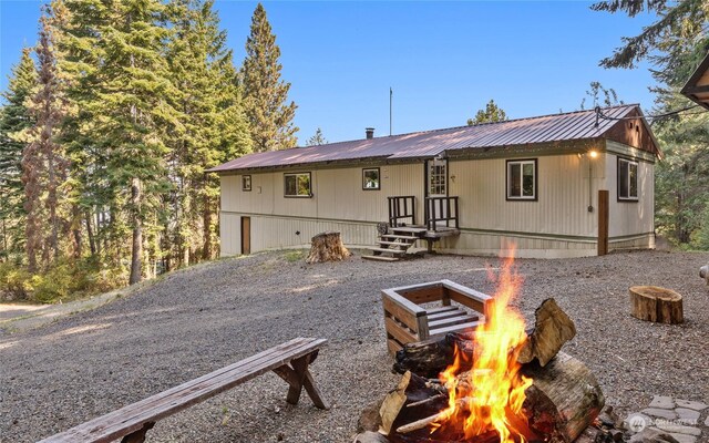 rear view of house with a fire pit