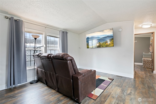 living room featuring dark hardwood / wood-style floors, a textured ceiling, and vaulted ceiling