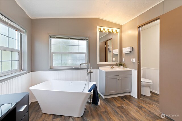 13708 108th Street Ct E Unit 4, Puyallup, WA 98374 - bathroom featuring a wainscoted wall, toilet, wood finished floors, vanity, and vaulted ceiling