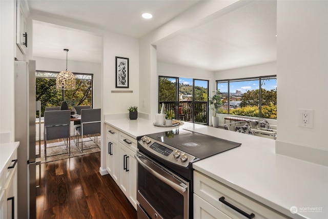 kitchen with white cabinetry, dark wood-type flooring, light countertops, and appliances with stainless steel finishes