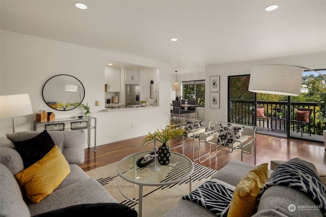 living area with plenty of natural light, recessed lighting, and wood finished floors