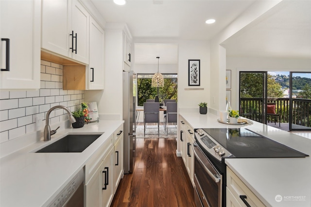 kitchen featuring a wealth of natural light, stainless steel appliances, sink, and white cabinets