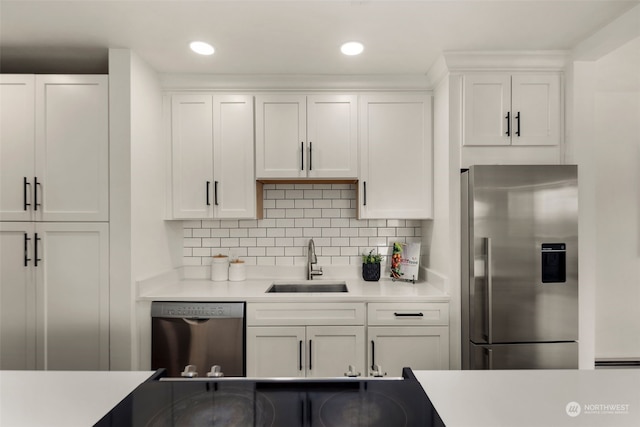 kitchen featuring light countertops, white cabinets, appliances with stainless steel finishes, and a sink